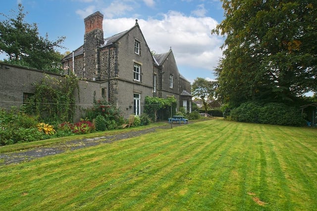 There is a large lawn at the back of the main house with a paddock beyond the garden.