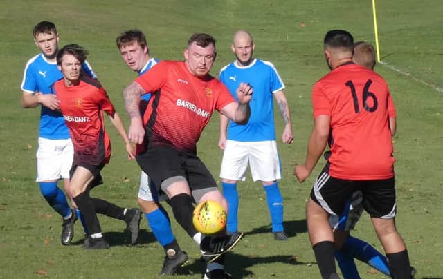 Action from Grassmoor Sports Res (in red) against Walkers Wanderers. All photos by Martin Roberts.