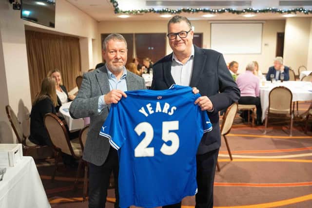 CFC director Ashley Kirk (right) presents a celebratory 25th shirt to Peter Clark of Graysons