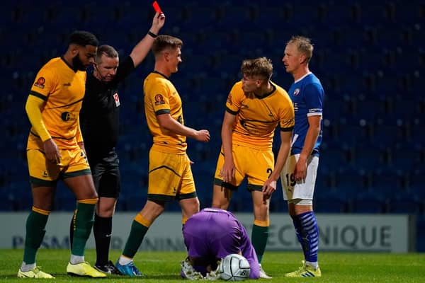 Referee Steve Copeland shows Chesterfield's Scott Boden a red card.