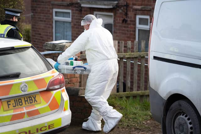 Police forensic officers at work in Warsop.