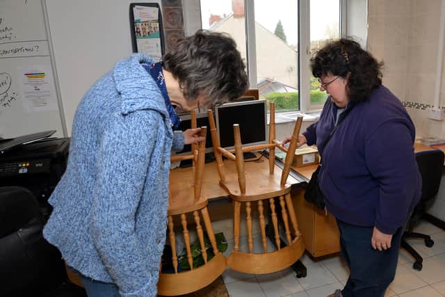 Margaret Hersee checks out a customer's chairs that need a repair at Monkey Park Social Enterprise, Chesterfield.