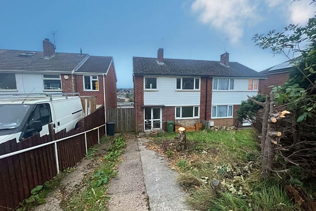 The property at 23 Newbridge Lane, Chesterfield, has front and rear gardens, a drive and a garage at the back of the house.
