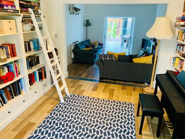 The living room has a music/ library area.