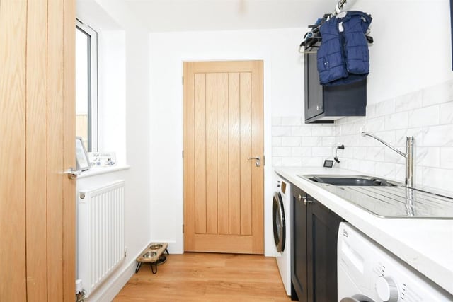 Just off the kitchen/diner is this utility room, which has plumbing for a washing machine and dryer. The room is fitted with wall and base units, plus work surfaces incorporating a stainless steel sink and drainer with mixer tap.
