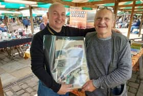 Mark Watterson, left, with Chesterfield market stallholder Ray Heard and the folder containing photos of Joe Davis and his wife June Malo (photo courtesy of Mark Watterson)