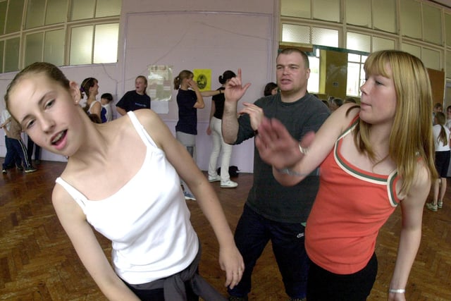 Amy Bashforth (left) and Jodie Walston (right) taking part  in a stage "fight" under the watchful eye of Andrew Shepherd at the Performing Arts Summer School being held at the Burton Street Project in August 2000