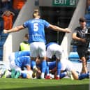 Ash Palmer is mobbed by his team-mates after scoring against Oldham Athletic. Picture: Tina Jenner.
