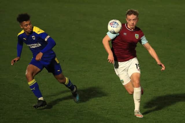 Michael Mellon, pictured right, in action fo Burnley's academy.