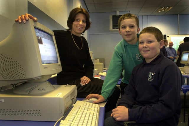 The opening of the new IT suite at the School  happened back in 2003. Left to right, one of the sponsors, Jackie Collins, of Jackie Collins School of drama gets shown one of the cumputers by pupils, Fionn Woodcock and Wallace Cuthbertson, both aged 11.