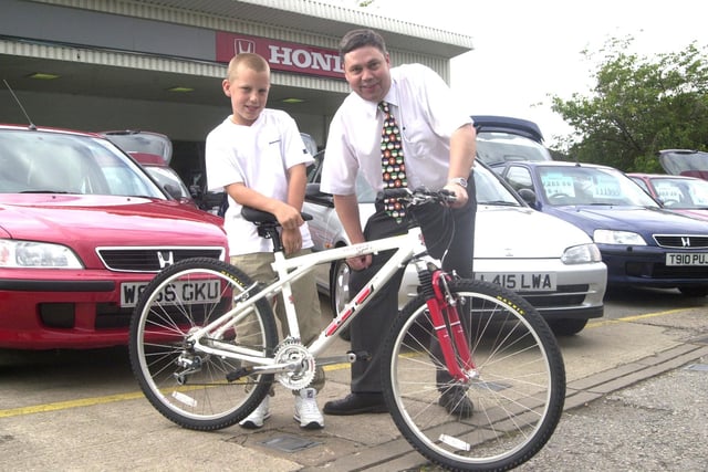 Peter Brookes Honda dealers, Chesterfield Road, Woodseats, Sheffield, where Service Manager Keith Whitehead handed over a new bike to Christopher Plumtree age 11 who had is bike stolen.