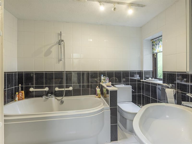 As well as the en-suite shower room, there is a further house bathroom which is fitted with a white suite, complete with a bath and overhead shower.