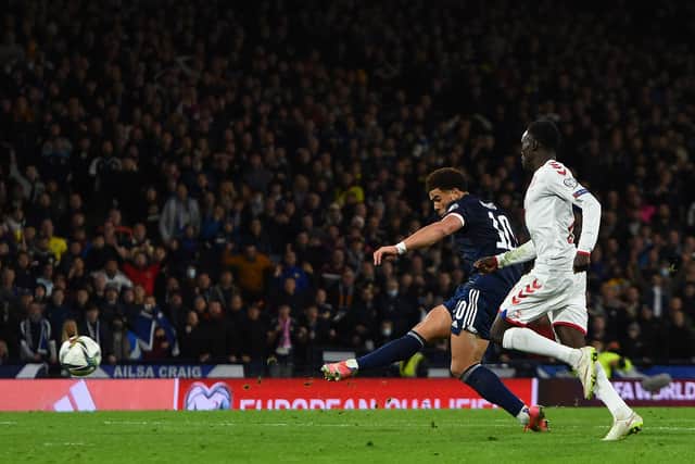 Scotland's Che Adams (L) scores his team's second goal during the FIFA World Cup 2022 Group F qualification football match between Scotland and Denmark at Hampden Park in Glasgow. (Photo by ANDY BUCHANAN/AFP via Getty Images)