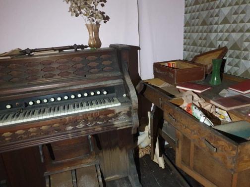 A piano stands in one of the rooms