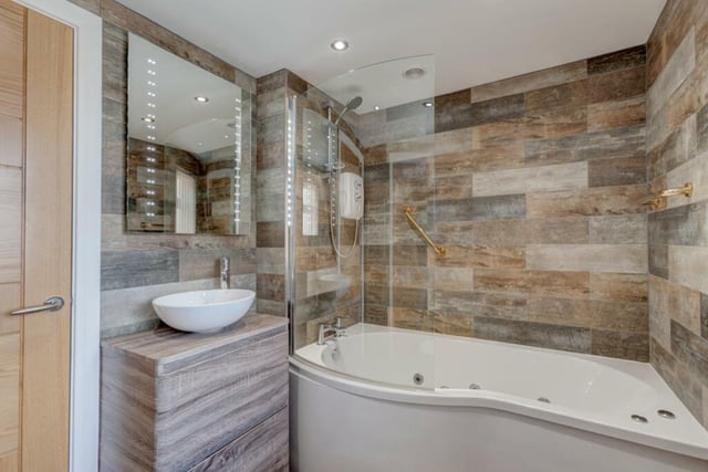 The Nook's bathroom contains a spa bath with overhead shower, a hand basin and wc.