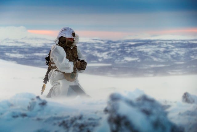 A Royal Marines assault engineer of 45 Commando prepares a charge during ice demolition training in the Arctic Circle. This image won the Global Operations Prize. By Leading Photographer Stevie Burke