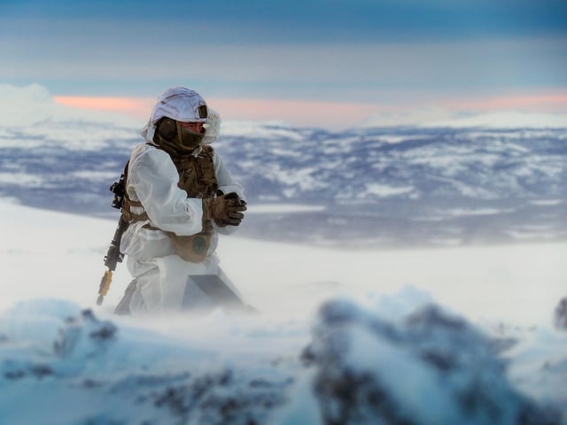 A Royal Marines assault engineer of 45 Commando prepares a charge during ice demolition training in the Arctic Circle. This image won the Global Operations Prize. By Leading Photographer Stevie Burke