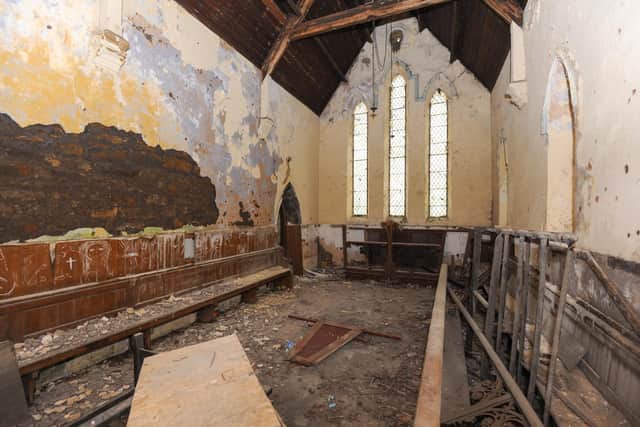 Stained glass windows and pews remain in the former chapel.