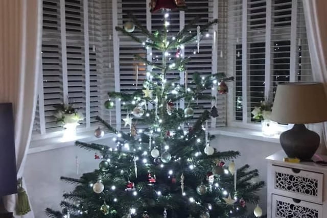Diane Keenan has finished her tree with an angel on top.