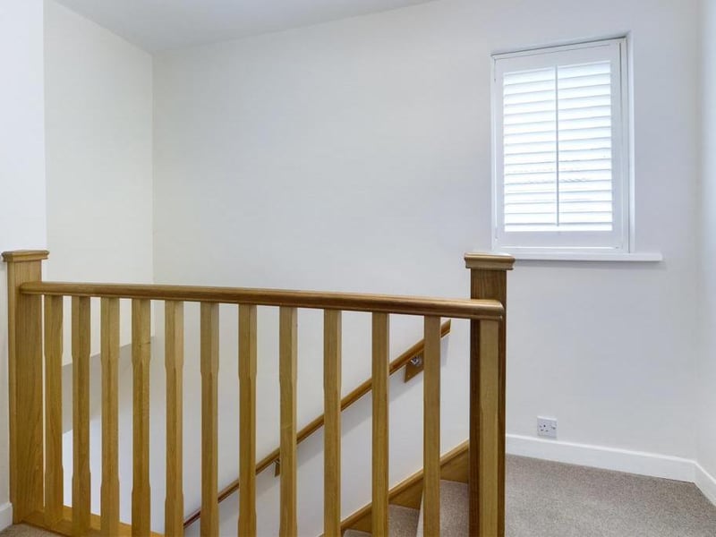 Landing - Wall mounted Oak hand rail and Oak spindled balustrade rail to landing, uPVC double glazed window to the side elevation, loft access, power point and fitted linen closet housing the wall mounted hgas boiler.