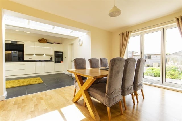 Part of the open-plan area is this dining room, a generously-sized reception room that overlooks and opens on to the patio in the back garden via bi-folding doors.