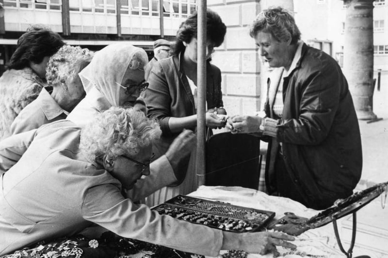 The jewellery stall of Mrs Betty Topping attracts interest in 1984.