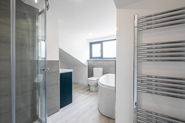 Here's a further glimpse of the bathroom, showing the heated towel rail and separate shower enclosure.