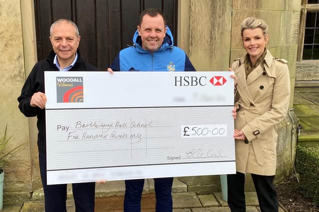 Martin Bruno (left) and Claire Wood of Woodall Homes present the cheque to Richard Stevenson, head of sport at Barlborough Hall School