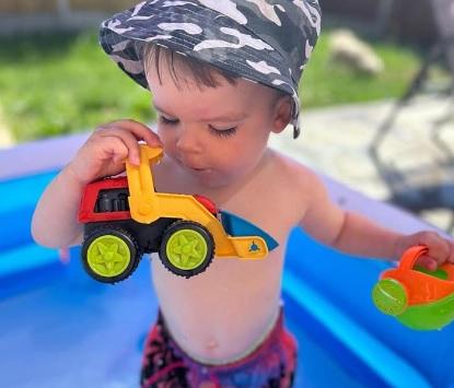 Michelle Towndrow posted this photo of a little boy playing with his toys in a paddling pool.