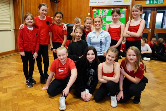 Ellie Simmonds visits Staveley Junior School as one of the House Groups is names after her. Ellie seen with some of the dancers before assembly.