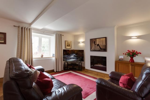 Completing the impressive set of ground-floor reception rooms is this relaxing lounge, which is a good size and faces the front of the Heath property. It features a contemporary, inset gas fire with a granite surround, and oak flooring.