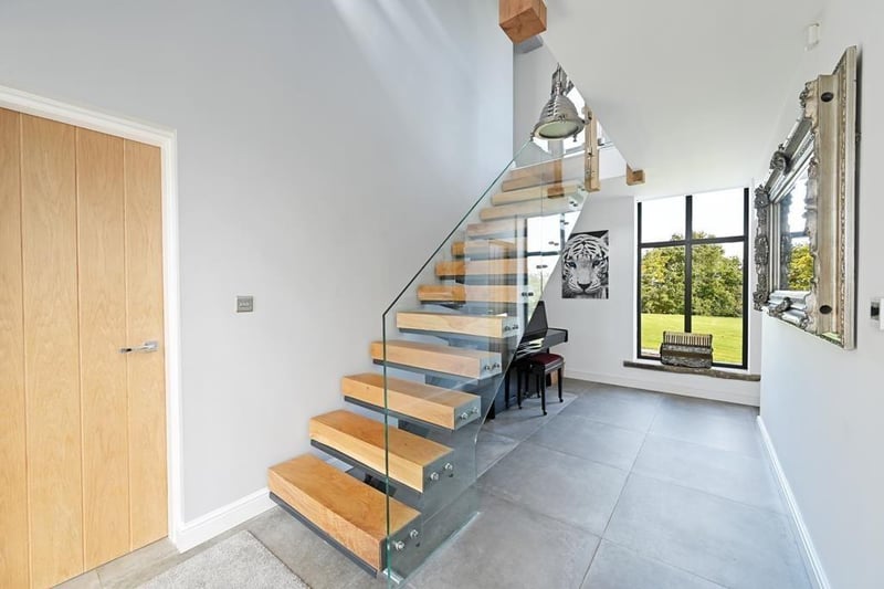 The "contemporary steel and oak" staircase works its way up to the amazing second floor. (Photo courtesy of Zoopla)