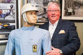 Rob Arnold with the Sir Stirling Moss racing suit which he is selling.