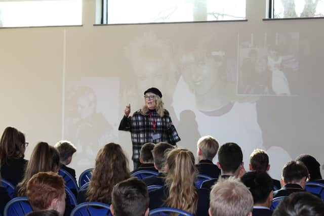 Sharon Bull addresses pupils at a school.