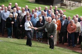 Derbyshire Chief Constable Rachel Swann welcomed to the reunion of Derbyshire police cadets by Michael McElhinney,  watched by other ex Derbyshire cadets.