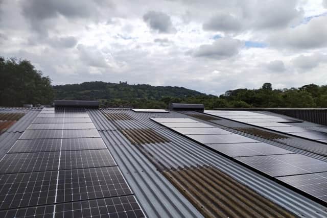 Solar panels on Twiggs' roof with Riber Castle in the background