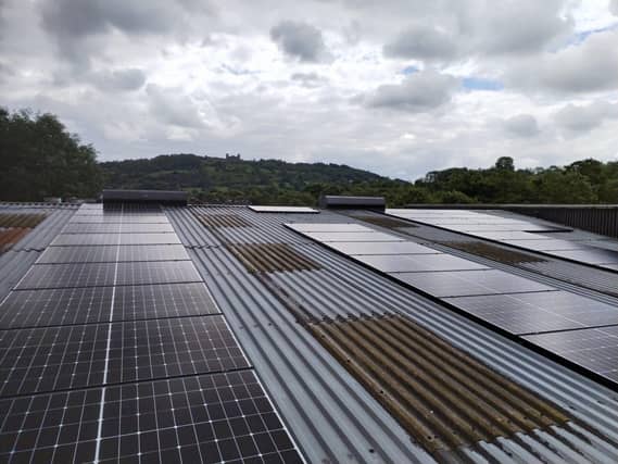 Solar panels on Twiggs' roof with Riber Castle in the background