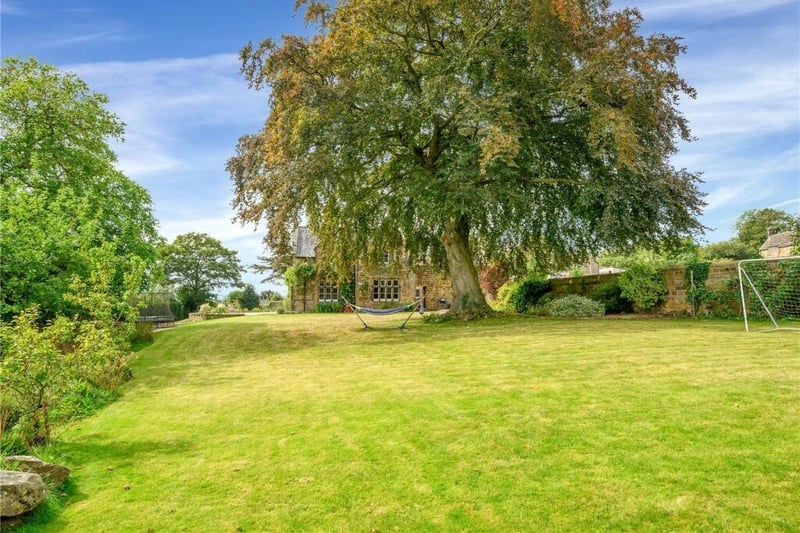A large lawn enables young legs to run off steam while older members of the family relax in the shade of a magnificent beech tree.  At the end of the garden behind a pond and screened by yew hedges, there is an additional grassed space with a greenhouse and vegetable beds.