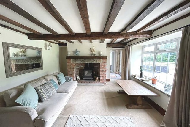 A log burning stove housed in an exposed brick fireplace, beamed low ceilings and deep skirting are features of the beautiful lounge where views over the extensive rear gardens can be enjoyed.