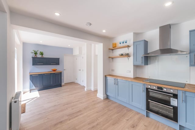 The open-plan kitchen and diner has a modern oven, an extractor fan and plenty of storage.