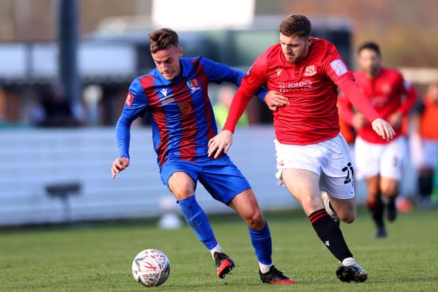 Samuel Coombes of Maldon & Tiptree FC is challenged by Morecambe's Ryan Cooney in the FA Cup first round. (Photo by James Chance/Getty Images)