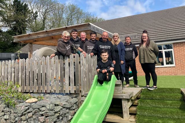 The team from PB Landscapes with Mark Harrison and Maria Hanson MBE from me&dee join Taylor Lewis and mum Terri in his newly made over garden