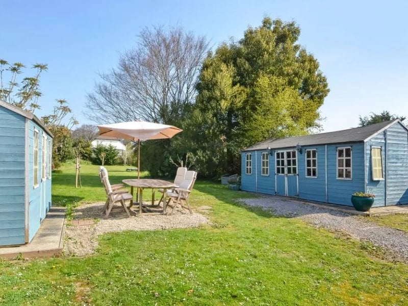In the garden there is a workshop and a store room.