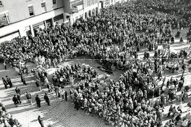 Chesterfield marketplace filled with people for the visit by the Prince and Princess of Wales,  November 1981.