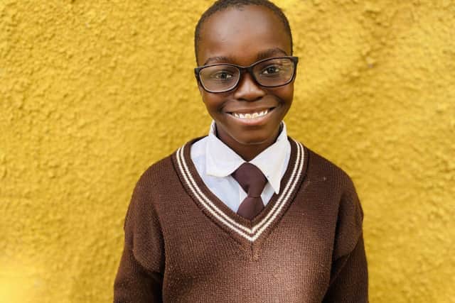 Child receiving spectacles from Vision Action