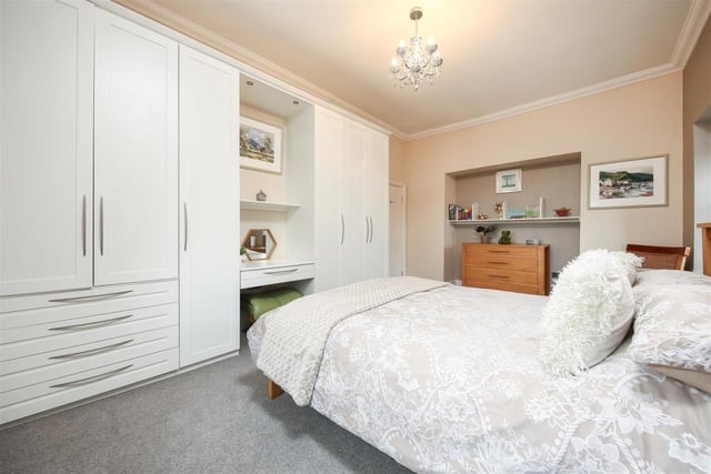 This pretty room has plenty of space to store clothes, shoes and accessories in the fitted wardrobes.