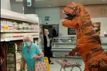 Samuel Hutchison donned a dinosaur costume to take his grandmother Mary shopping