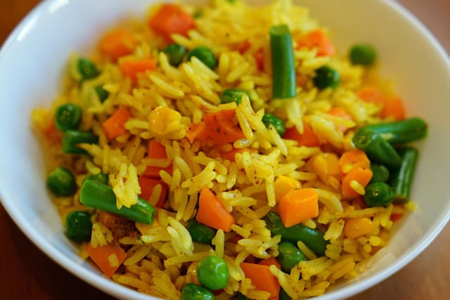 Deceptively simple fried rice is cooked in stock to give its unique flavour.