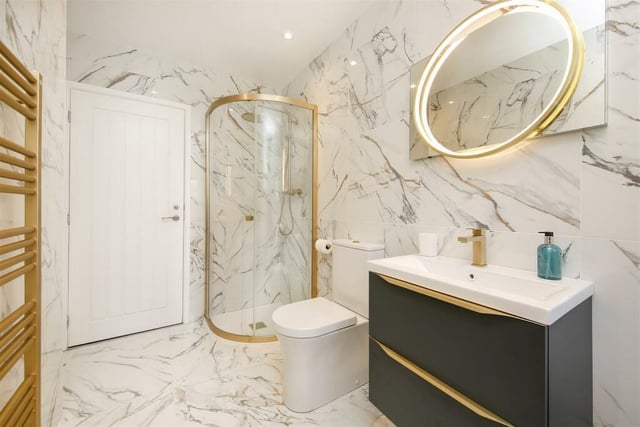 The luxuriously refurbished master bathroom on the ground floor has  a shower and brassware.