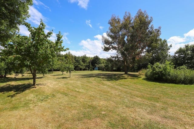 The property stands on a 1.2-acre plot with mature grounds that have lawns, landscaped gardens and seating areas.